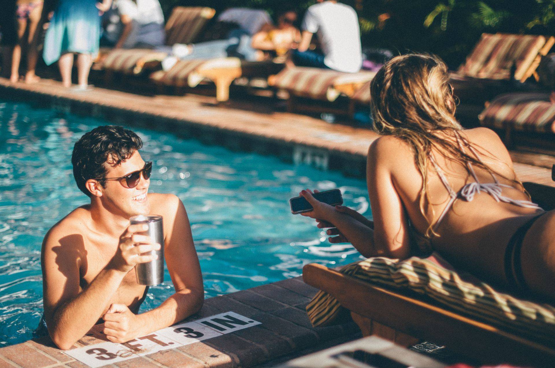 Couple relaxing by the pool